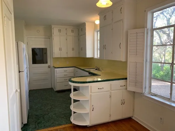 a kitchen with a sink and a stove top oven