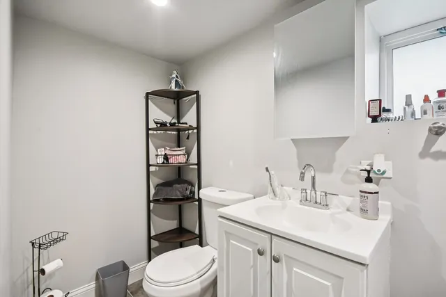 a bathroom with a sink toilet vanity and mirror