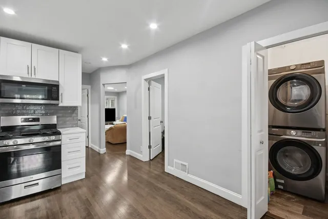 a view of a kitchen with a stove top oven and cabinets