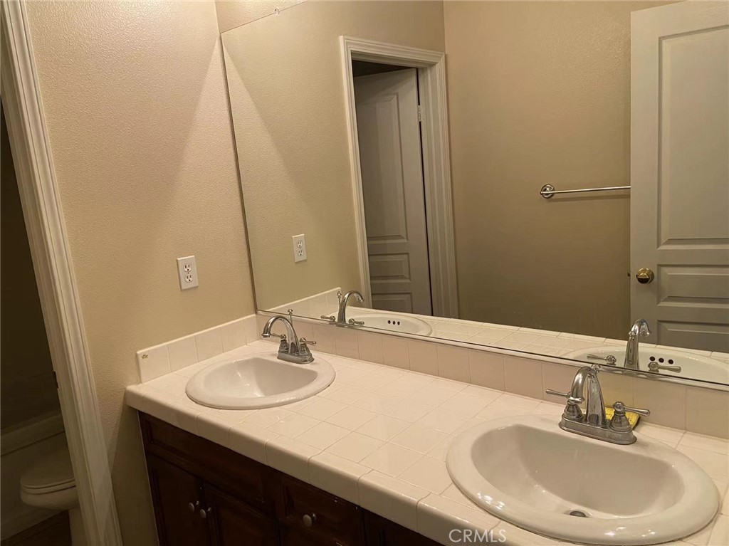 187 Wild Lilac Irvine, CA 92620 - Photo 13 of 16 a bathroom with a sink and a mirror