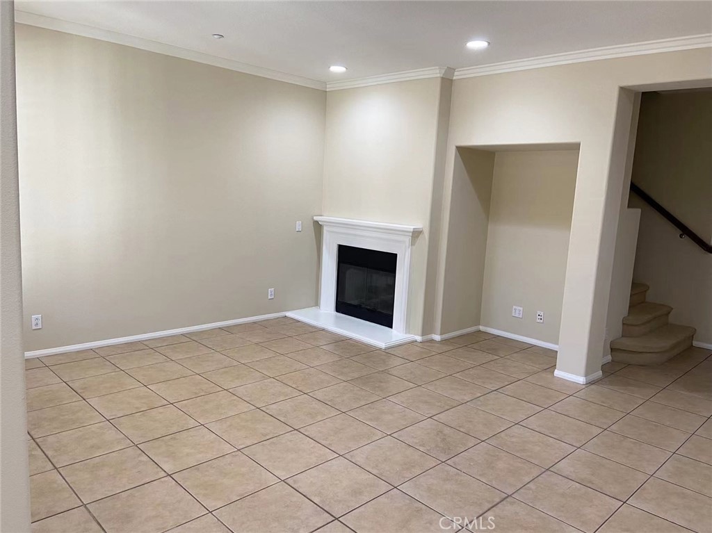 187 Wild Lilac Irvine, CA 92620 - Photo 3 of 16 a view of an empty room with a fireplace