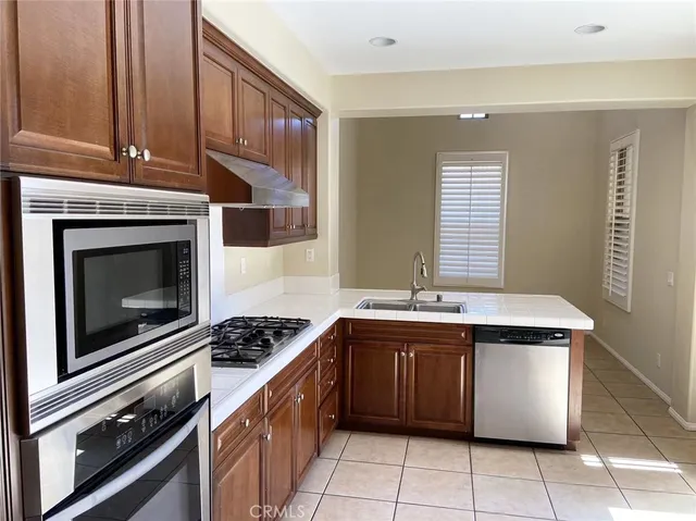 a kitchen with a stove sink and cabinets