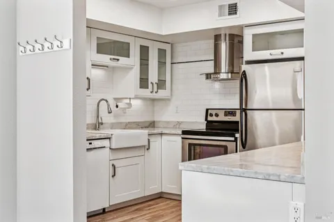 a kitchen with cabinets appliances and a sink