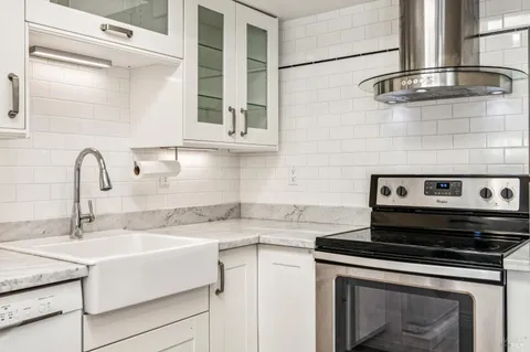 a kitchen with a stove and a sink