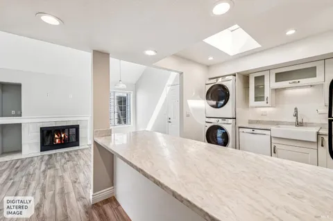 a kitchen with a stove a sink and a fireplace