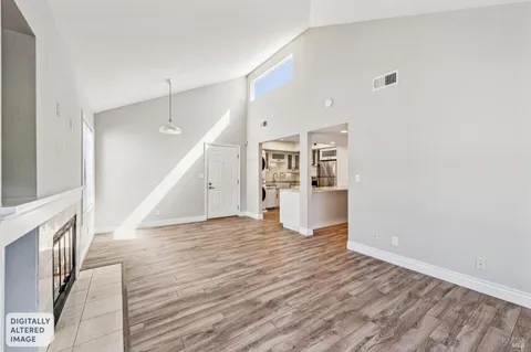 a view of a kitchen with wooden floor and entryway