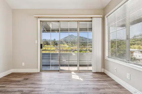 an empty room with wooden floor and a window