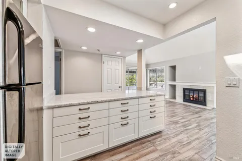 a spacious bathroom with a granite countertop sink and a mirror