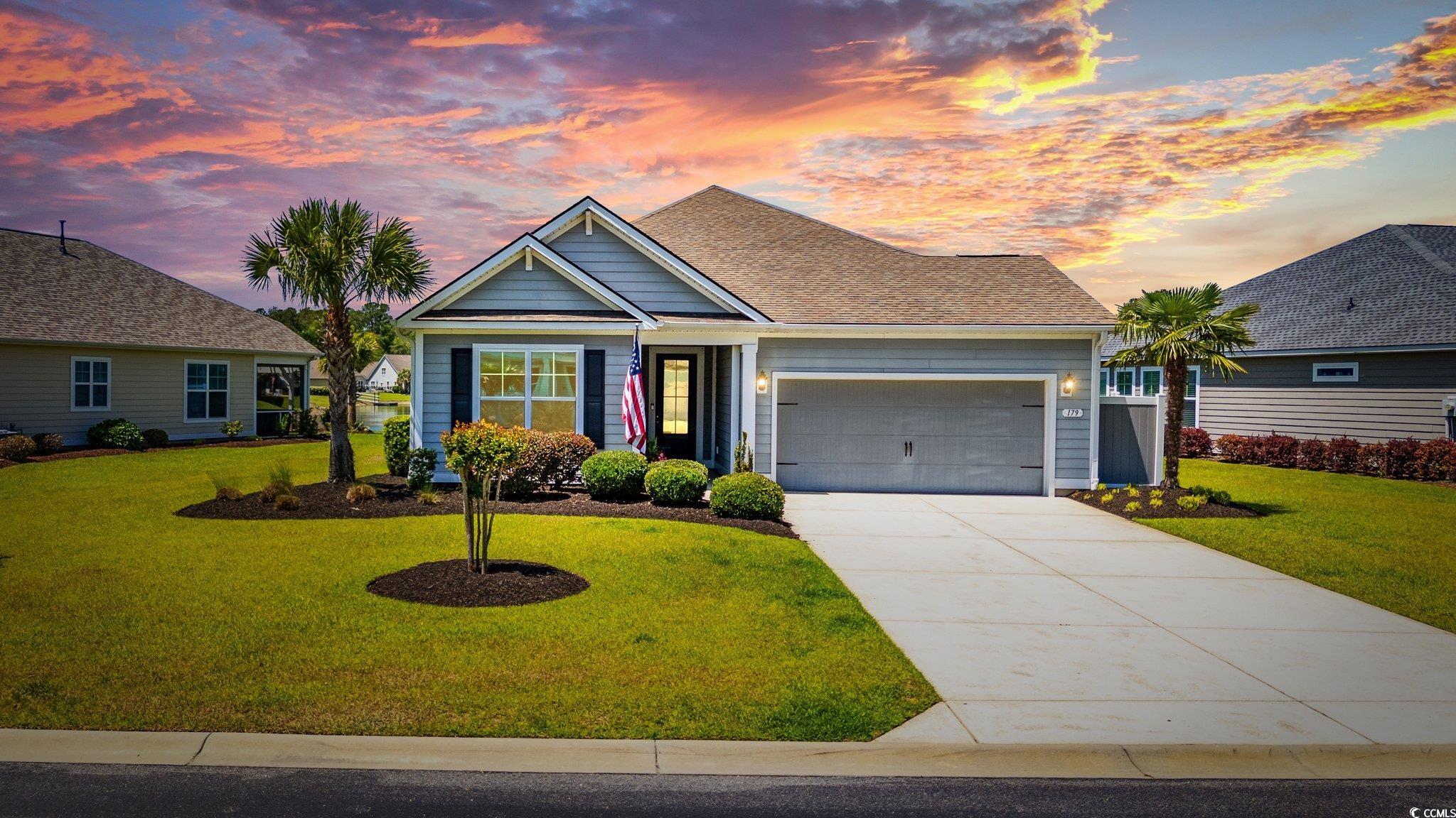 179 Hyacinth Loop Murrells Inlet, SC 29576 - Photo 2 of 40 View of front facade with a lawn, an attached garage, and driveway
