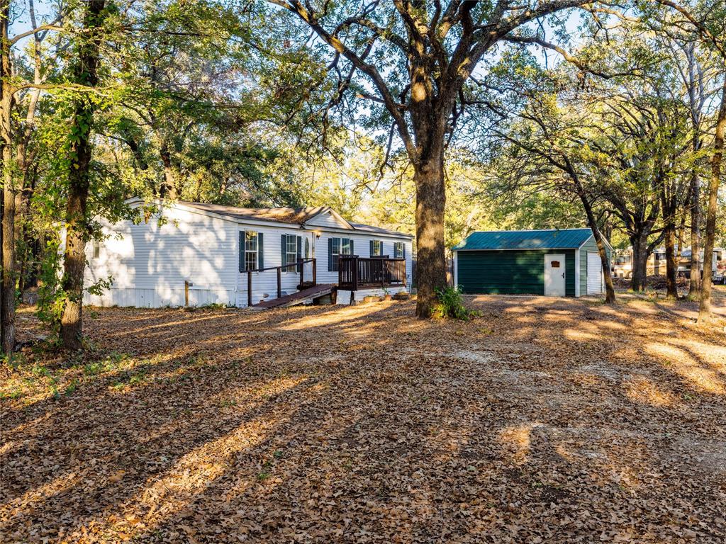 202 Forgotten Lane Mabank, TX 75156 - Photo 3 of 36 a view of a house with a yard