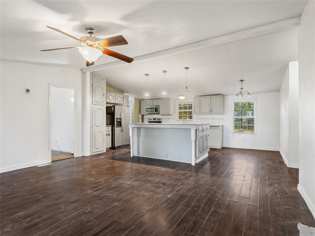 202 Forgotten Lane Mabank, TX 75156 - Photo 34 of 36 a view of a kitchen with wooden floor and a window