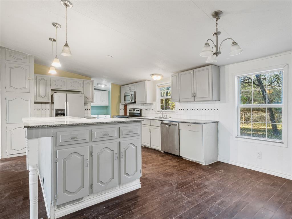 202 Forgotten Lane Mabank, TX 75156 - Photo 6 of 36 a kitchen with white cabinets and white appliances