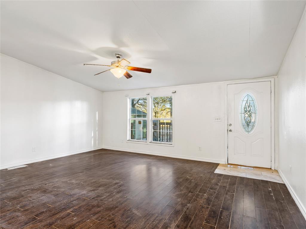 202 Forgotten Lane Mabank, TX 75156 - Photo 8 of 36 an empty room with wooden floor and window