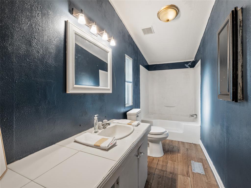 202 Forgotten Lane Mabank, TX 75156 - Photo 10 of 36 a bathroom with a sink a toilet and shower