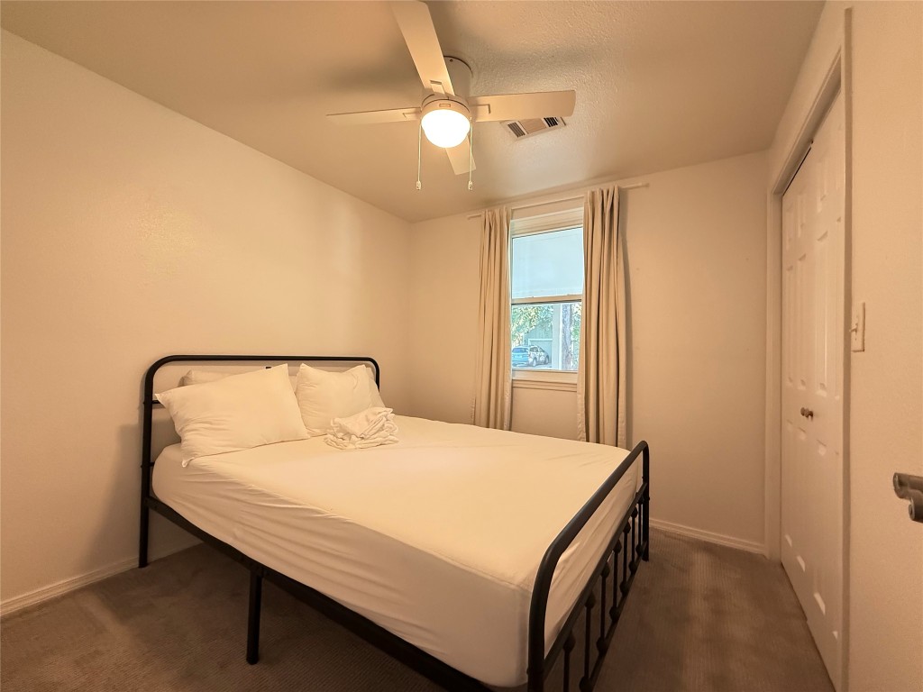 505 East 4th Street Georgetown, TX 78626 - Photo 1 of 18 a bedroom with a bed and a chandelier