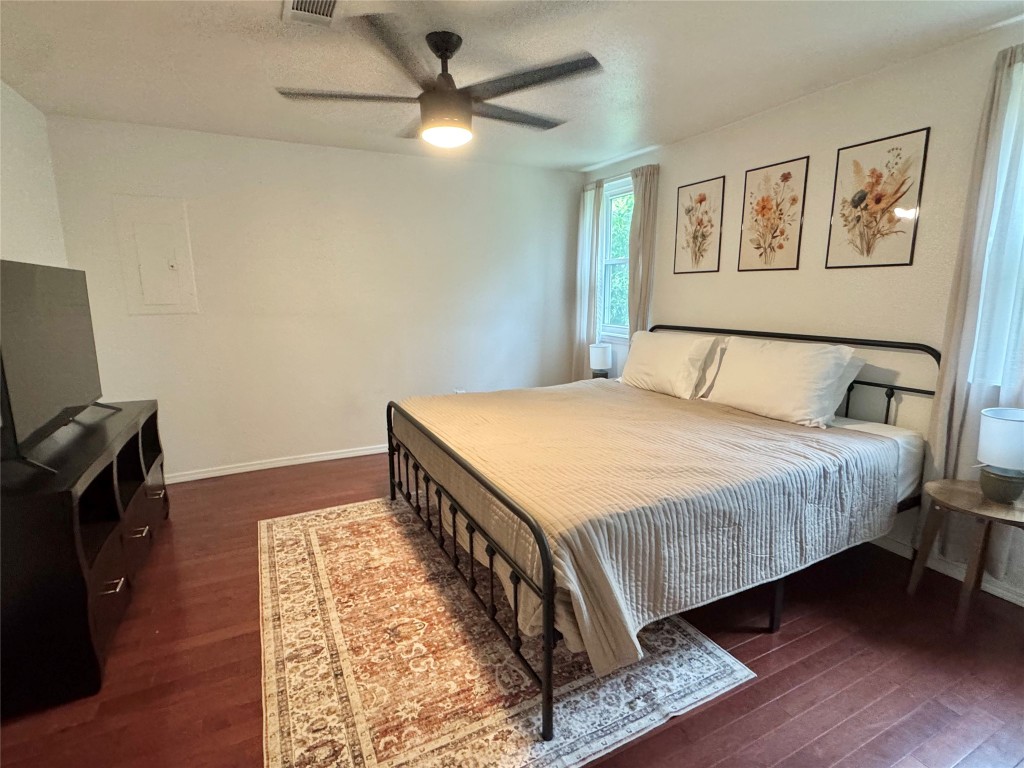 505 East 4th Street Georgetown, TX 78626 - Photo 11 of 18 a bedroom with a bed and wooden floor