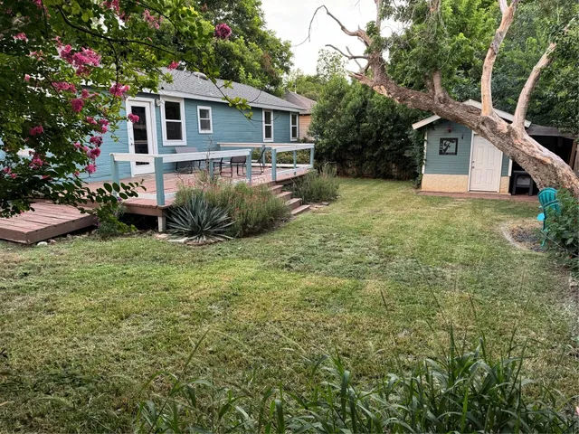 a view of a house with yard and a garden