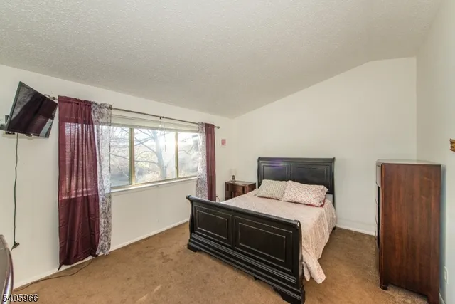 a bed room with a bed and a night stand