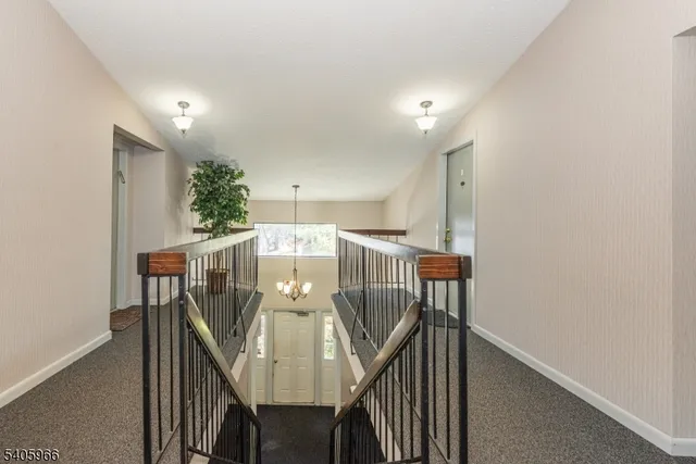 a view of staircase with railing and a window