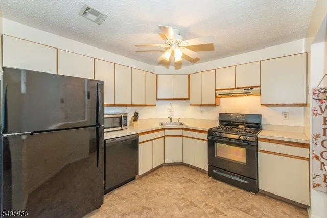 a kitchen with stainless steel appliances granite countertop white refrigerator stove a sink and dishwasher