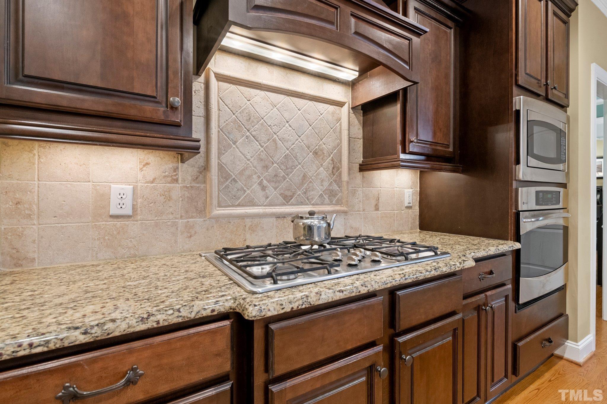 52 Evening Lane Clayton, NC 27527 - Photo 11 of 58 a kitchen with granite countertop a sink stove and cabinets