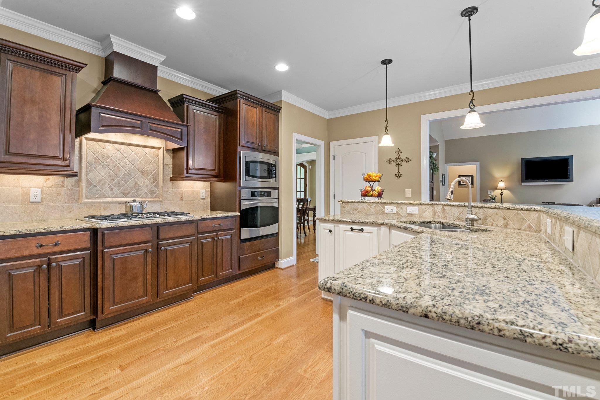 52 Evening Lane Clayton, NC 27527 - Photo 12 of 58 a large kitchen with kitchen island a large counter top appliances and cabinets