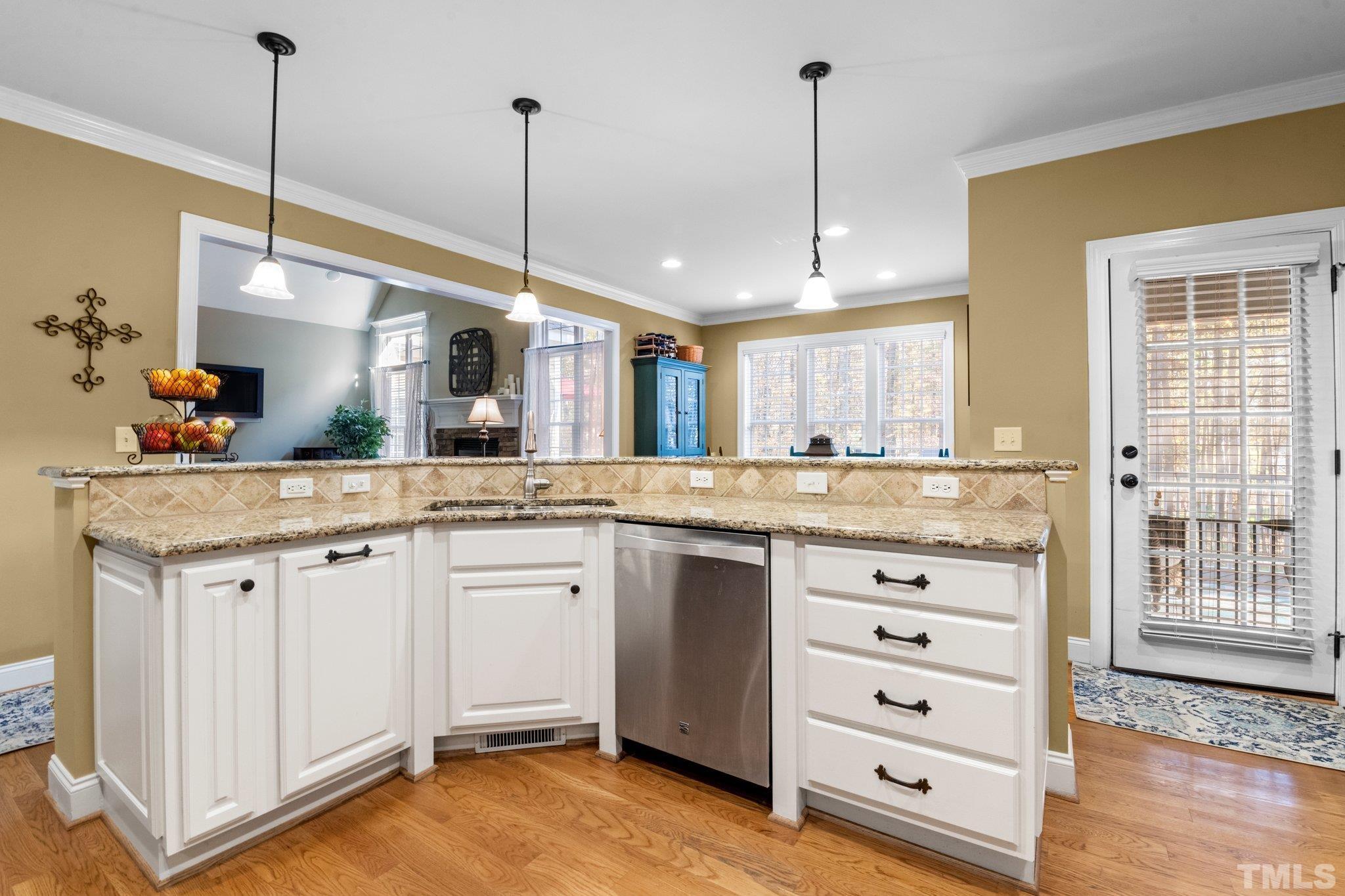 52 Evening Lane Clayton, NC 27527 - Photo 13 of 58 a kitchen with granite countertop a sink cabinets and wooden floor