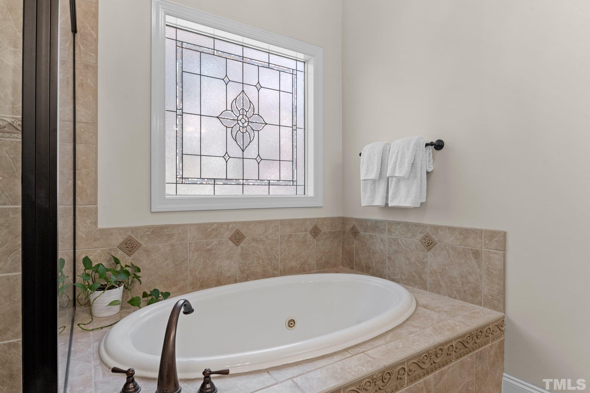 52 Evening Lane Clayton, NC 27527 - Photo 22 of 58 a bathroom with a tub and a window
