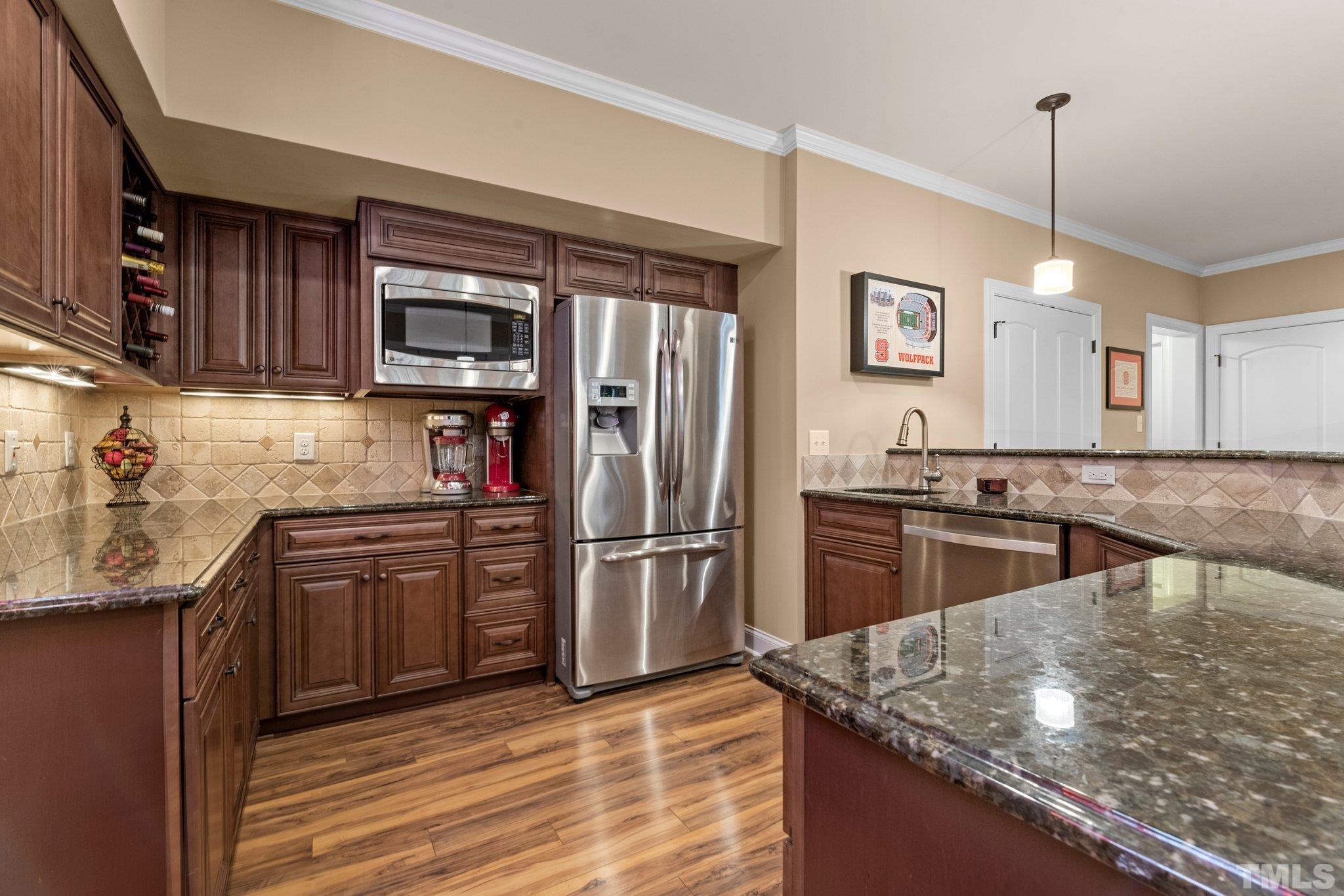 52 Evening Lane Clayton, NC 27527 - Photo 29 of 58 a kitchen with stainless steel appliances granite countertop a refrigerator a stove and a sink