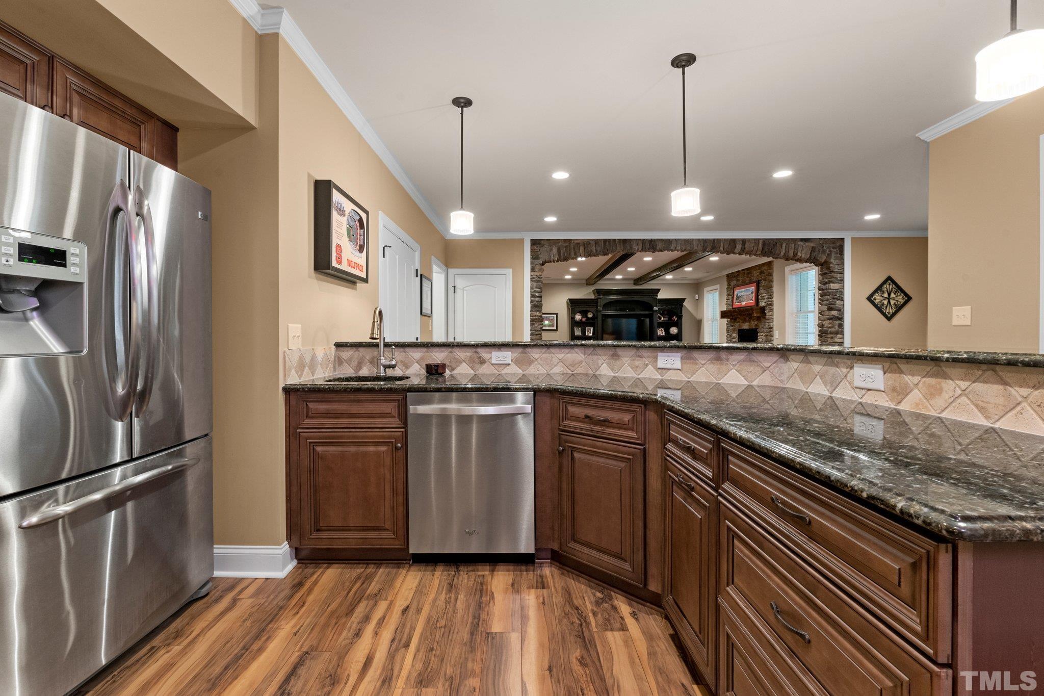 52 Evening Lane Clayton, NC 27527 - Photo 30 of 58 a kitchen with stainless steel appliances granite countertop a refrigerator a sink and a stove