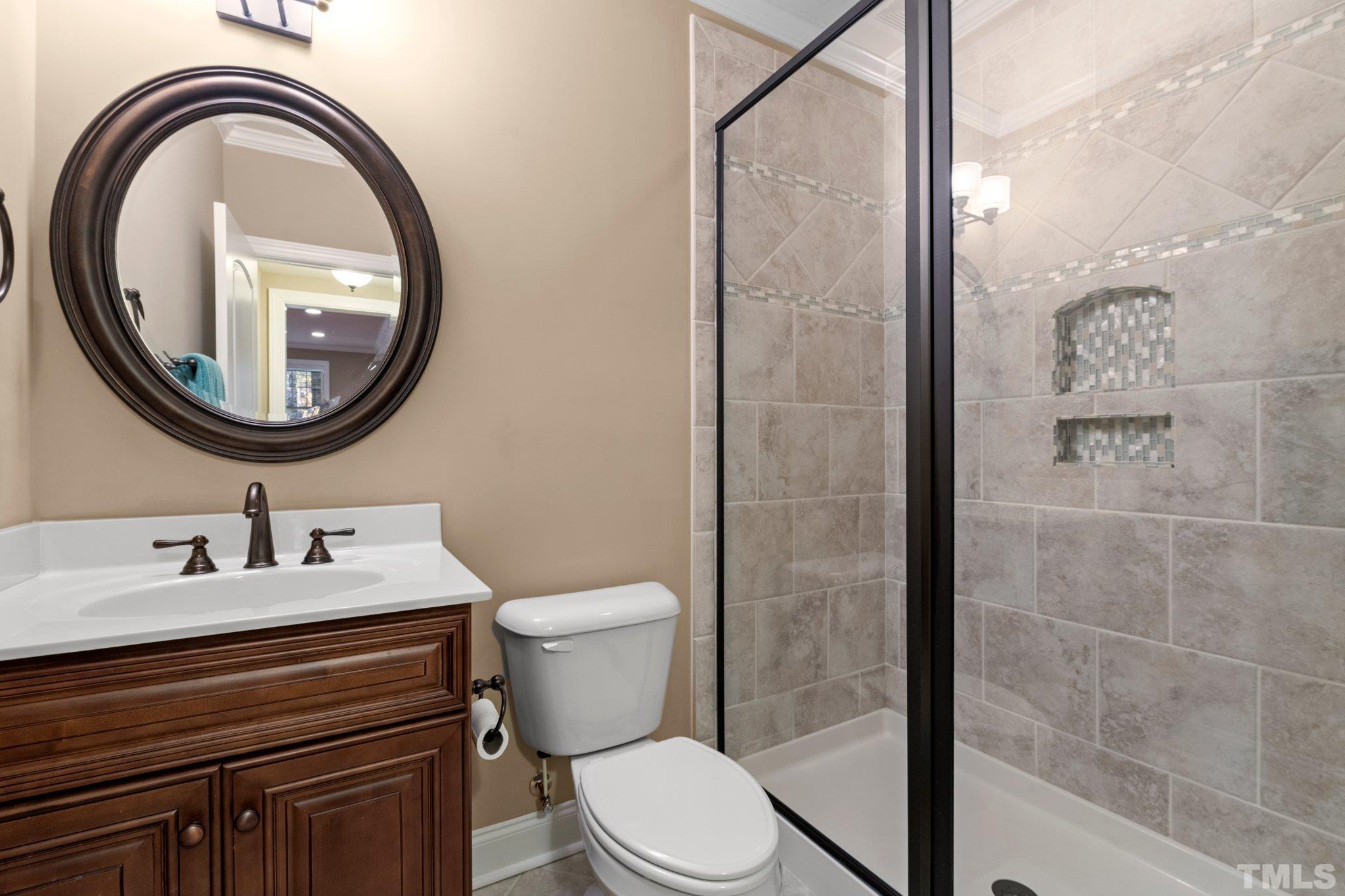 52 Evening Lane Clayton, NC 27527 - Photo 31 of 58 a bathroom with a toilet a sink and a mirror