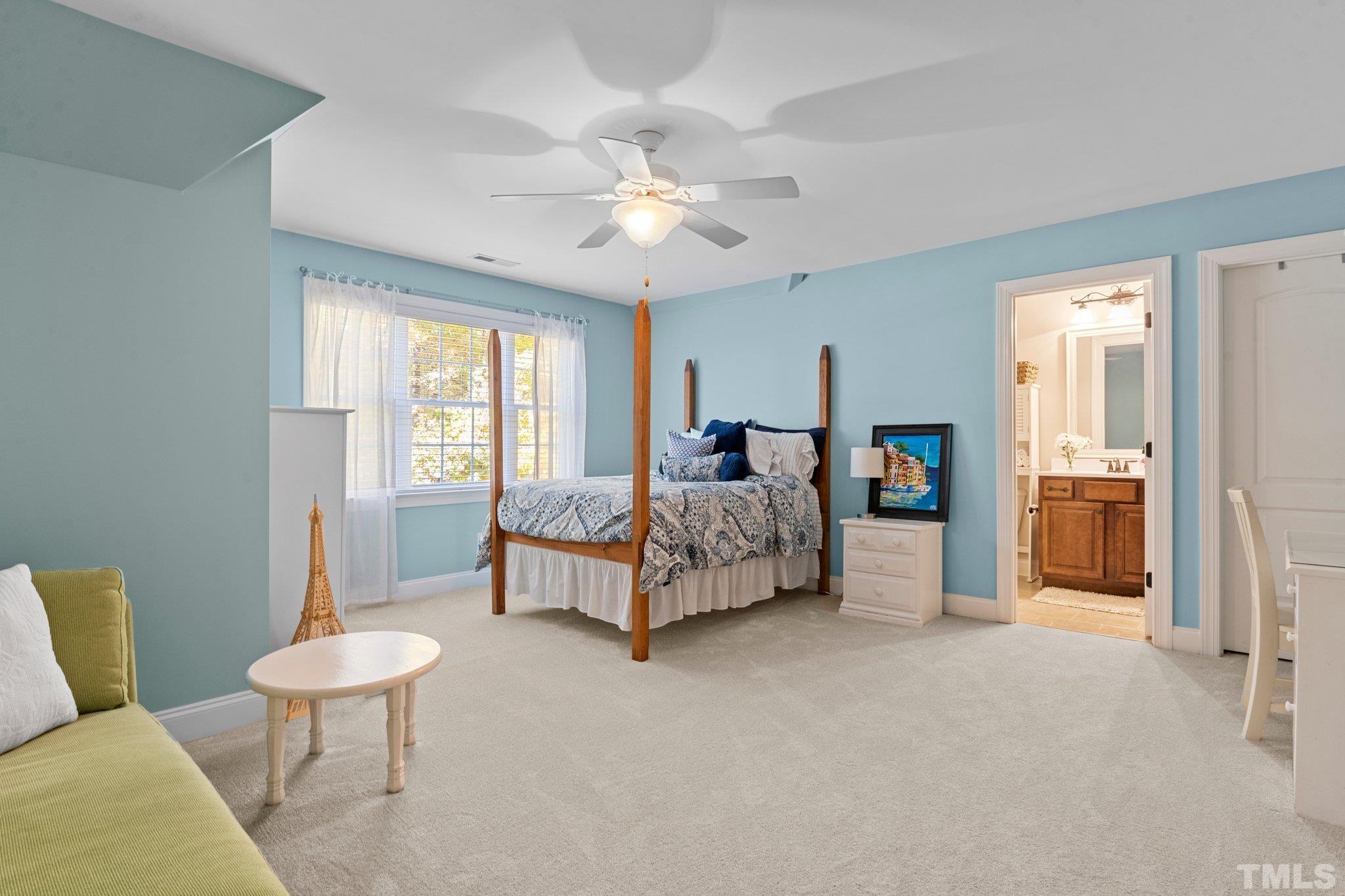 52 Evening Lane Clayton, NC 27527 - Photo 34 of 58 a spacious bedroom with a bed and a chandelier