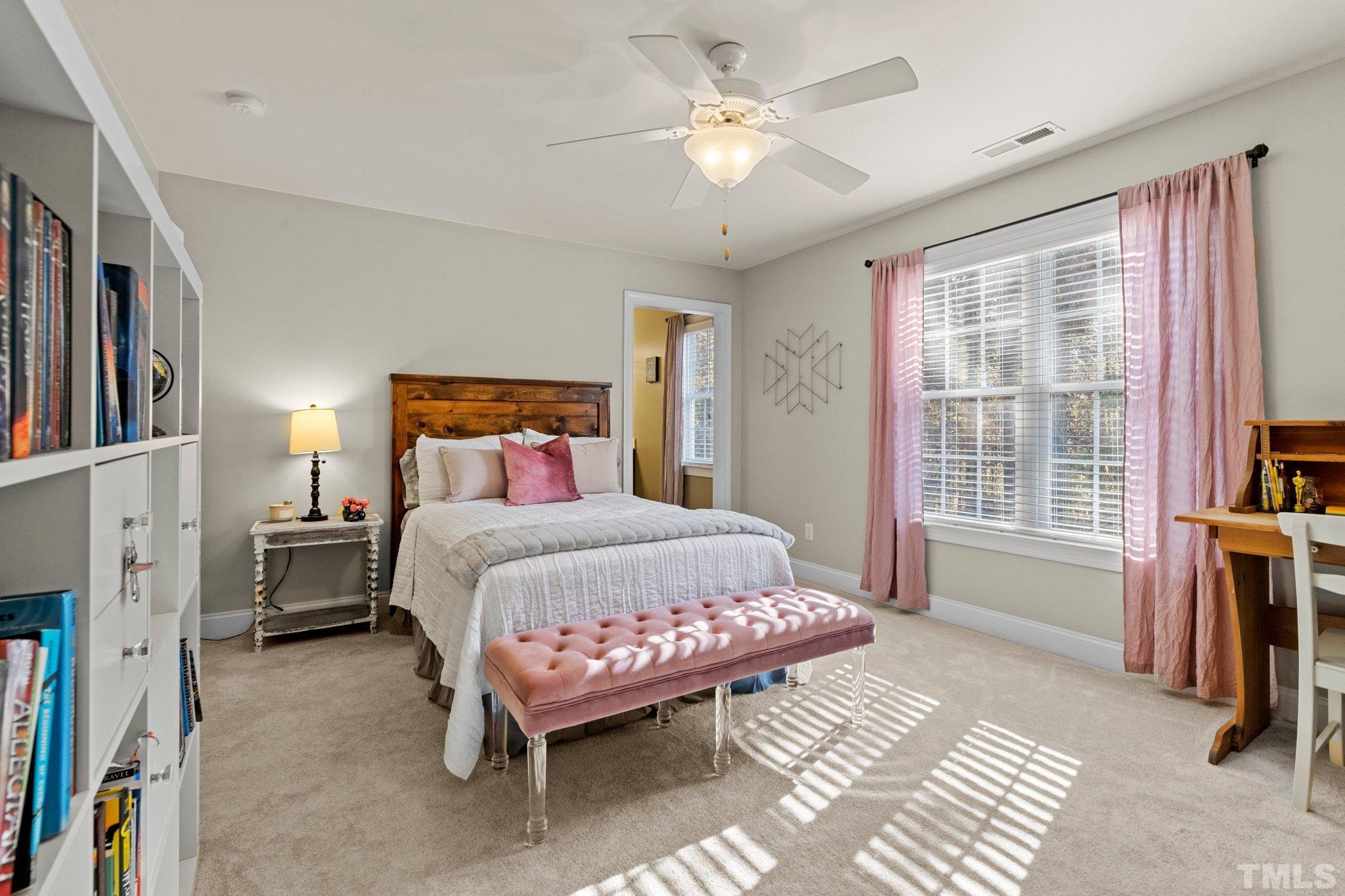 52 Evening Lane Clayton, NC 27527 - Photo 36 of 58 a bedroom with a bed flat screen tv and a large window