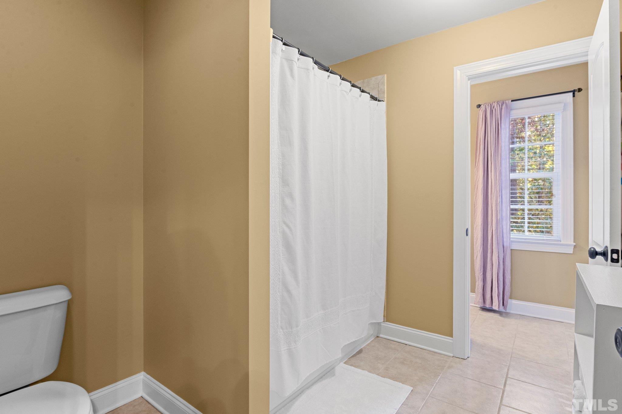 52 Evening Lane Clayton, NC 27527 - Photo 37 of 58 a bathroom with a toilet and a shower