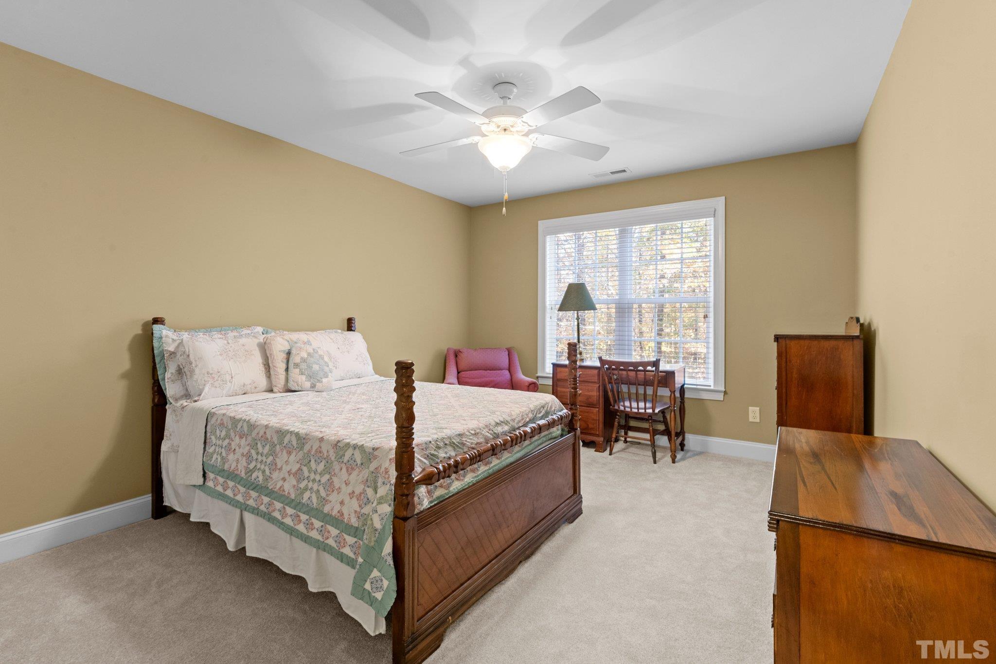 52 Evening Lane Clayton, NC 27527 - Photo 39 of 58 a bed room with a bed and a chair