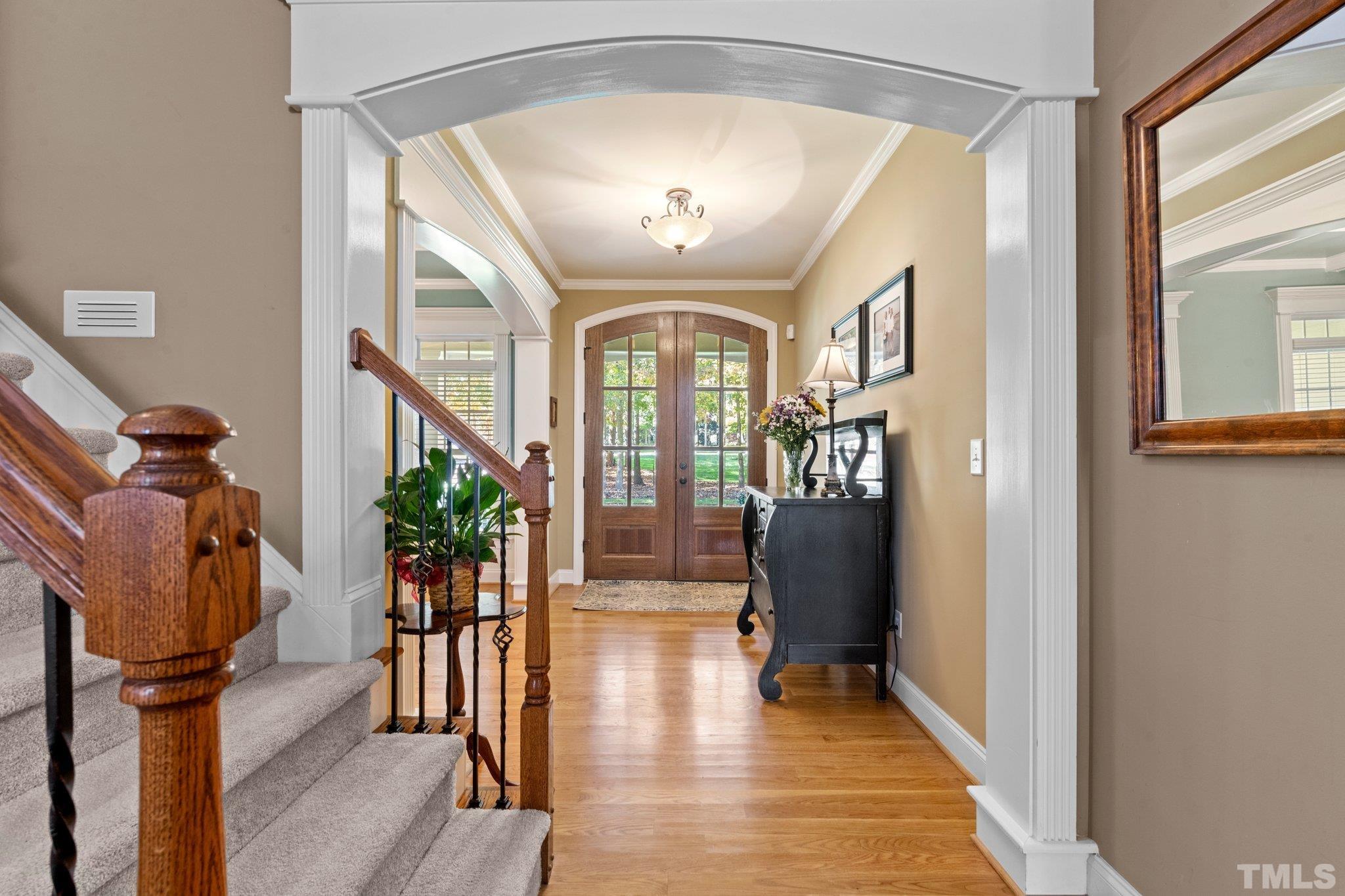 52 Evening Lane Clayton, NC 27527 - Photo 7 of 58 a view of a hallway with wooden floor and stairs