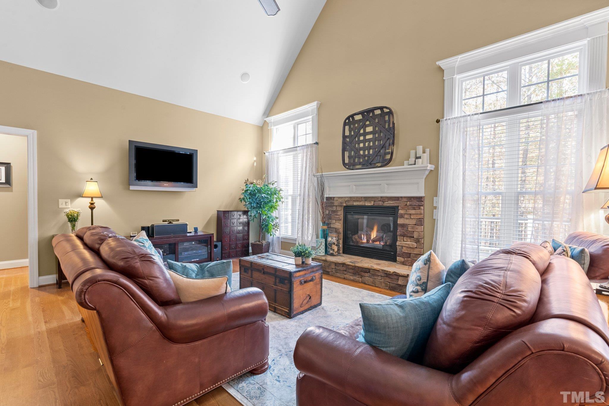 52 Evening Lane Clayton, NC 27527 - Photo 9 of 58 a living room with furniture a large window and a fireplace