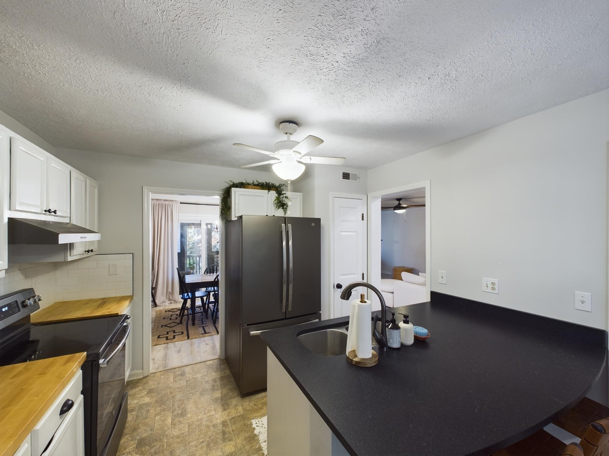 705 Broad Leaf Circle, Unit 705 Raleigh, NC 27613 - Photo 6 of 31 a kitchen with stainless steel appliances granite countertop a sink refrigerator and cabinets