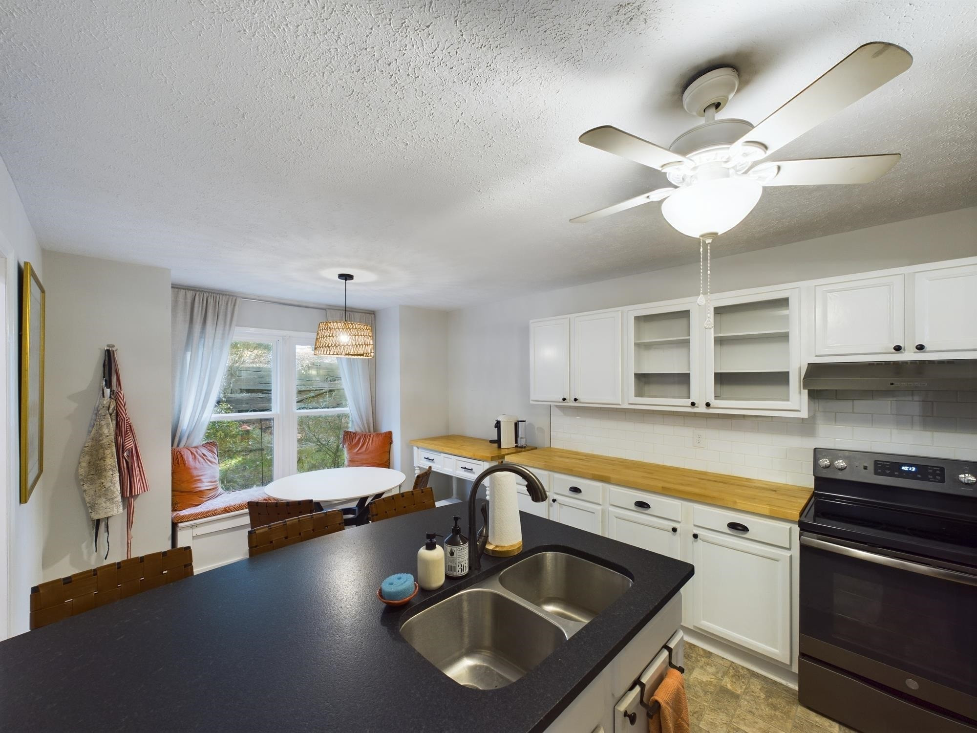 705 Broad Leaf Circle, Unit 705 Raleigh, NC 27613 - Photo 8 of 31 a kitchen with stainless steel appliances granite countertop a stove a sink and a microwave