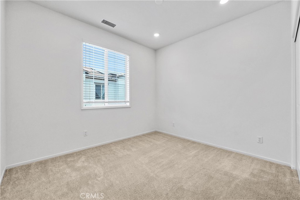 5584 Kate Way, Unit 10 Fontana, CA 92336 - Photo 23 of 42 an empty room with a window