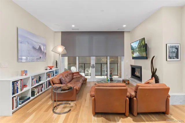 a living room with furniture a fireplace and a flat screen tv