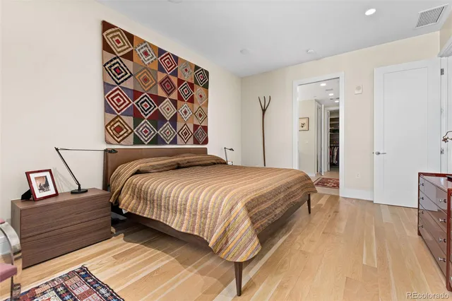 a spacious bathroom with a double vanity sink a mirror and a shower