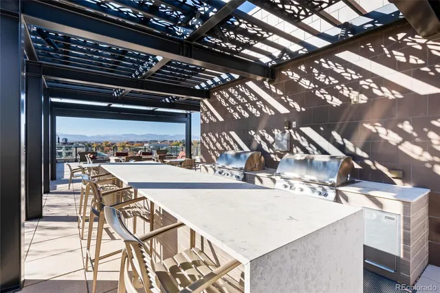 a living room with patio furniture and a floor to ceiling window