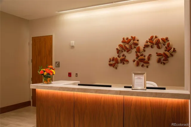 a large white kitchen with stainless steel appliances granite countertop a stove and a sink