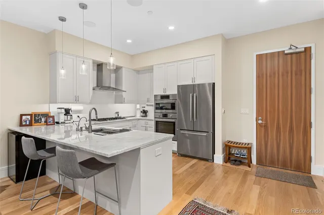 a kitchen with a sink stove and refrigerator