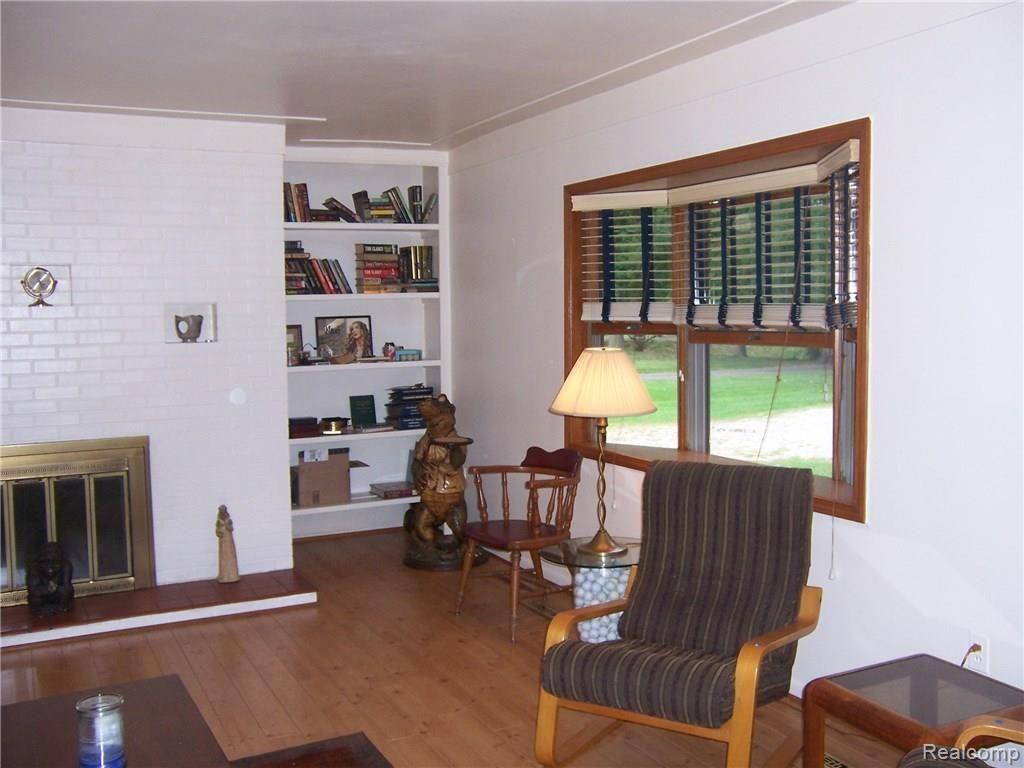 8036 Ferry Road Grosse Ile, MI 48138 - Photo 13 of 38 Living room with fireplace and built in shelves
