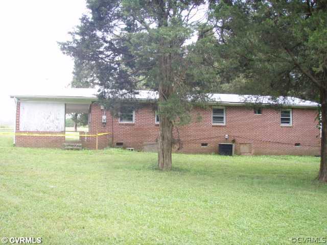 1775 Courthouse Road Louisa, VA 23093 - Photo 2 of 10 a backyard of a house with table and chairs