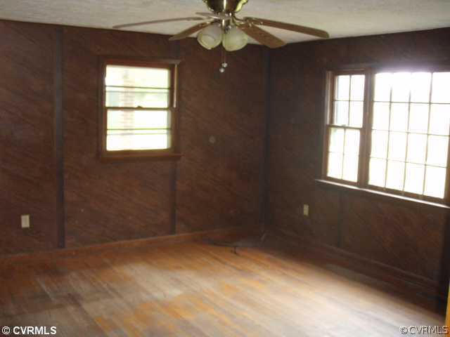 1775 Courthouse Road Louisa, VA 23093 - Photo 4 of 10 an empty room with windows and fan