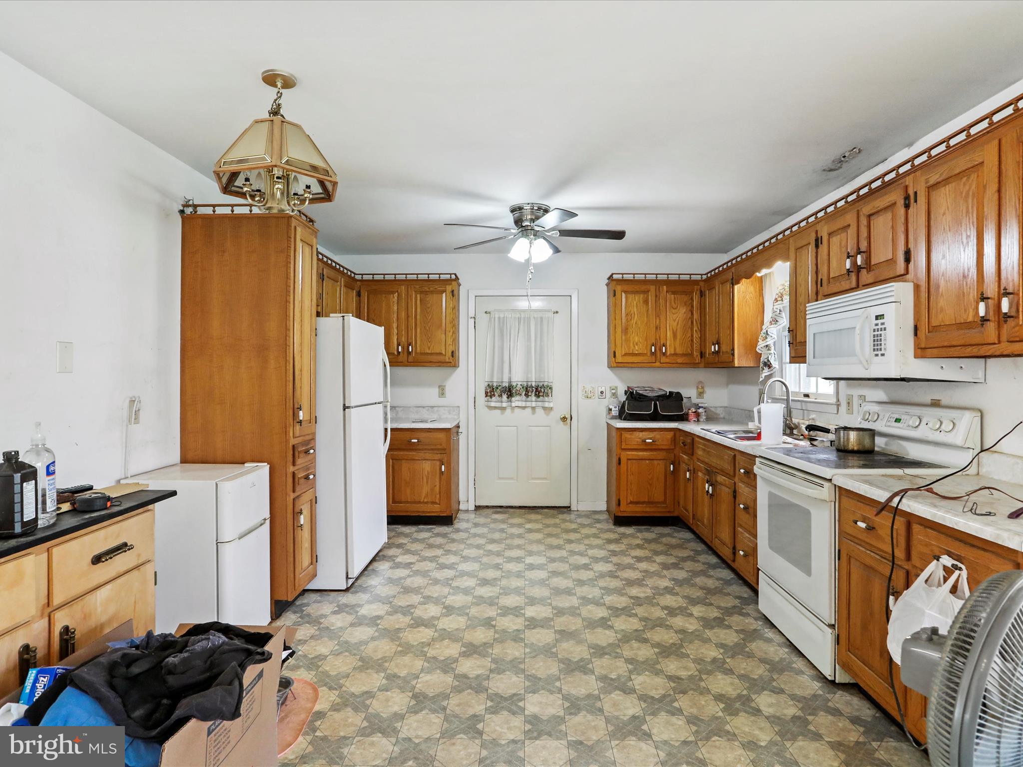 12440 Indian Springs Road Clear Spring, MD 21722 - Photo 12 of 35 a kitchen with stainless steel appliances a stove refrigerator sink and cabinets