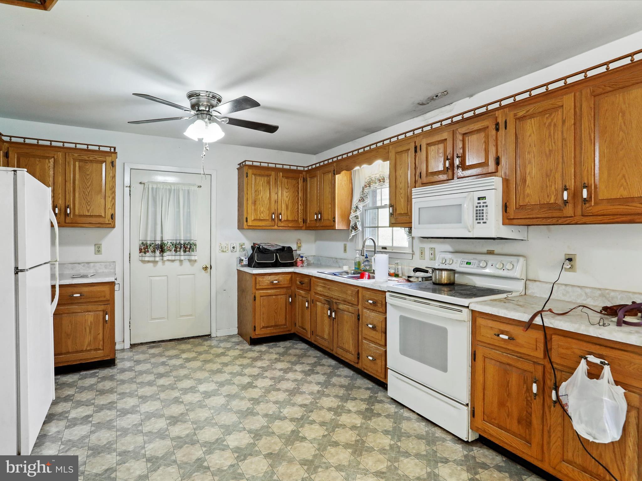 12440 Indian Springs Road Clear Spring, MD 21722 - Photo 13 of 35 a kitchen with stainless steel appliances granite countertop a stove a sink dishwasher a refrigerator and cabinets with wooden floor